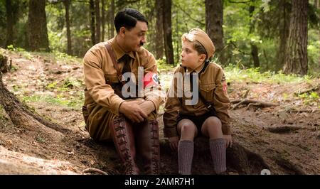 Jojo Rabbit (2019) directed by Taika Waititi and starring Taika Waititi as Adolf Hitler and Roman Griffin Davis as Johannes 'Jojo Rabbit' Betzler in a comedy based on Christine Leunens Caging Skies novel about the Hitler Youth. Stock Photo