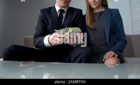 Successful couple receives credit from bank, lending to young perspective family Stock Photo