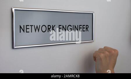 Network engineer office door, hand knocking closeup, database administrator Stock Photo