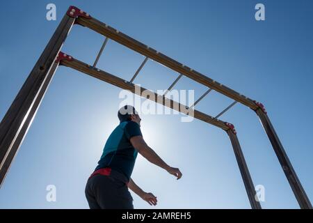 Man using outdoor beach gym in Spain Stock Photo