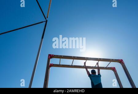 Man using outdoor beach gym in Spain Stock Photo