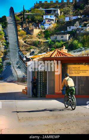 Border Patrol agent arrivng for work on his his bicycle at the U.S. Customs and Border Protection Morley Gate Border Station in Nogales AZ Stock Photo