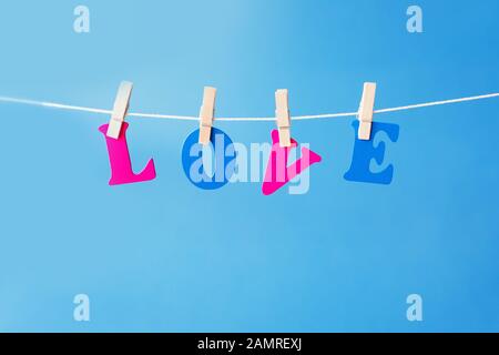 Clothes pegs and I LOVE YOU words on papers on rope on white background Valentines day concept Stock Photo
