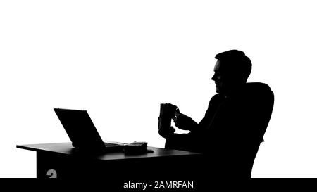 Businessman sitting in office and counting bundle of money, oligarch shadow Stock Photo