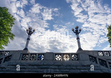 Two large street lamps. Vintage street lamps. Lights on a granite column. View from below. Stock Photo