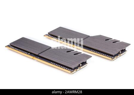a pair of ddr4 dimm pc ram memoty modules with stylish black heatsinks - isolated on white with selective focus. Stock Photo