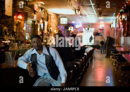 View of a man seated at a bar counter. Stock Photo