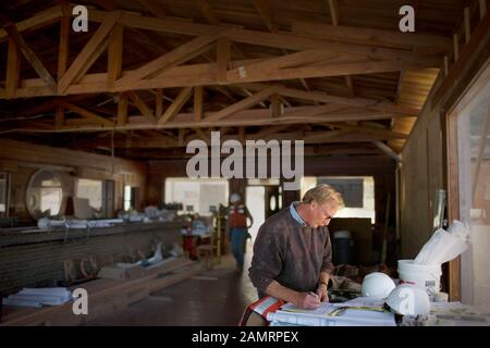 View of a man writing on a paper. Stock Photo