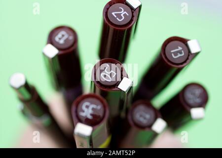 Technical drawing pens on green background. Stock Photo