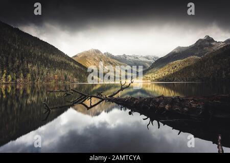 Mountain reflections in Wuxu Hai Lake, Jiulong County, Sichuan, China Stock Photo