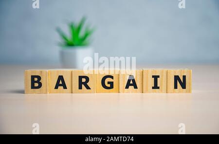 Text bargain on wooden cubes blue background. business concept Stock Photo