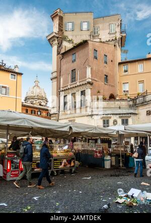 Rome, Italy - March 24, 2018: Shoppers browse market stalls in the Campo de' Fiori market square in Rome. Stock Photo