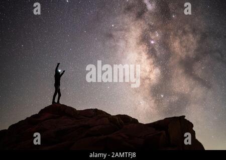 Silhouette of a hiker standing on mountain with is arms in the air, Sequoia National Park, California, USA Stock Photo
