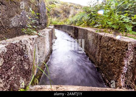 stone water channel full of running water in Tierra del Trigo village Stock Photo