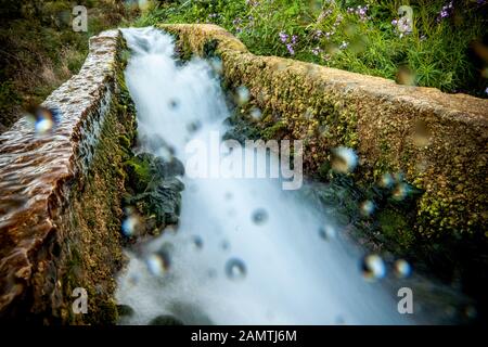 stone water channel full of running water in Tierra del Trigo village Stock Photo