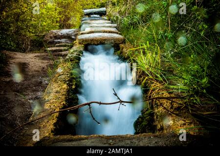 stone water channel full of running water in Tierra del Trigo village Stock Photo