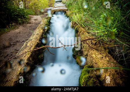 stone water channel full of running water in Tierra del Trigo village Stock Photo