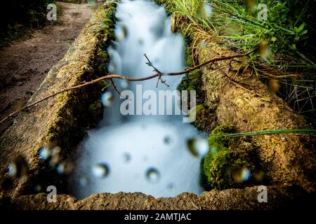 stone water channel full of running water in Tierra del Trigo village Stock Photo