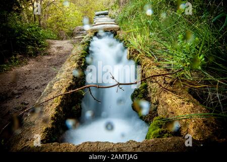 stone water channel full of running water in Tierra del Trigo village Stock Photo