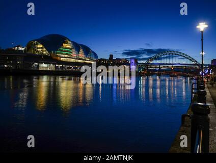 Looking across the River Tyne from Newcastle Quayside to the Sage Theatre in Gateshead on the south side of the river with the Tyne Bridge beyond. Stock Photo