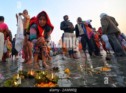 Namkhana, India. 14th Jan, 2020. NAMKHANA, INDIA - JANUARY 14 2020: Hindu devotee lighting lamps during the festival.Gangasagar is one of the religious spots for Hindu Pilgrims situated at the Bay of Bengal where millions of devotees come to take a Holy bath annually during Makar Sankranti (Transition of the Sun) as per Hindu calendar and offer prayers to Kapil Muni Temple. The date for this Festival usually fall between 13 to 15 January of every year. Credit: SOPA Images Limited/Alamy Live News Stock Photo