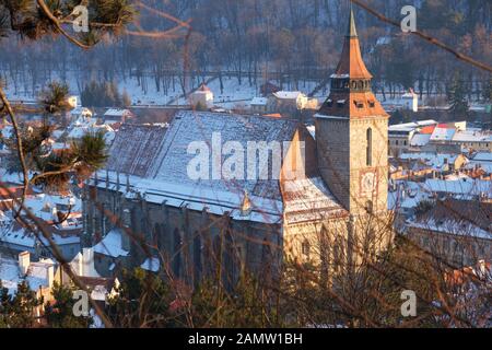Gothic-style Black Church of Brasov city, Romania, as seen from a high vantage point, at sunset, on a Winter day. Stock Photo