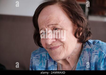 a portrait of an old woman making an expression of quiet and tranquility Stock Photo