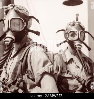 'Top Women' at U.S. Steel's Gary Works in Gary, Indiana, c1945. Wearing oxygen masks as a safety precaution, these women clean up at regular intervals around the tops of twelve blast furnaces. Stock Photo