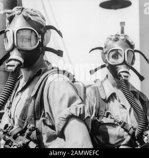 'Top Women' at U.S. Steel's Gary Works in Gary, Indiana, c1945. Wearing oxygen masks as a safety precaution, these women clean up at regular intervals around the tops of twelve blast furnaces. Stock Photo