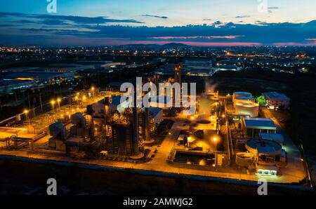 Aerial view night light oil terminal is industrial facility for storage of oil and petrochemical. oil manufacturing products ready for transport and b Stock Photo