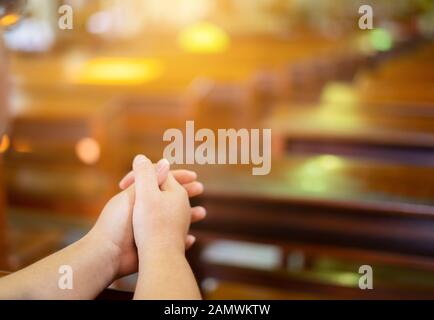 Woman hands are worship christian god while in church. Eucharist Therapy Bless God Helping Repent Catholic Easter Lent Mind Pray. Christian concept ba Stock Photo