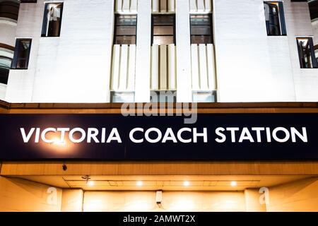 London, United Kingdom - June 20, 2018: Closeup of sign on building for bus stop buses transport service Victoria Coach Station at night