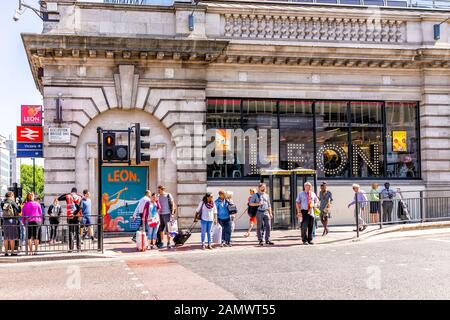 London, UK - June 27, 2018: Pimlico Victoria architecture buildings with Leon fast food and people walking crossing street on sunny summer day Stock Photo