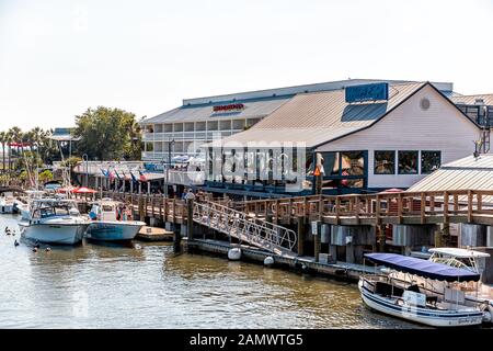 Mount Pleasant, USA - May 11, 2018: Charleston South Carolina with waterfront restaurants on Shem Creek and boats Stock Photo