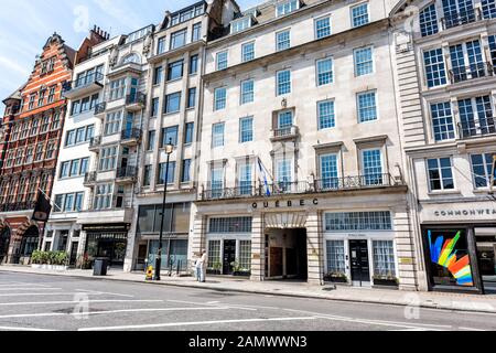 London, UK - June 24, 2018: Piccadilly Pall Mall street road in center of downtown city with Quebec Government Office in London and flag exterior Stock Photo