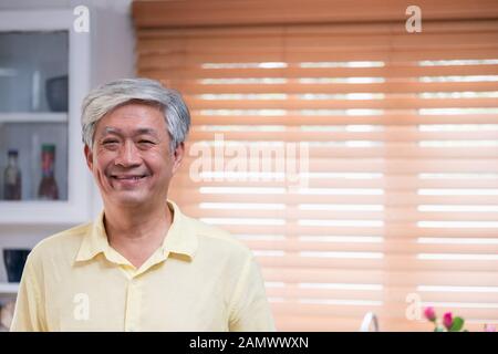 Asian senior man smile in living room at home,Happy aging at home concept. Stock Photo