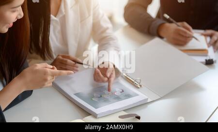 Close up view of business group analyzing on their project in modern co-working space Stock Photo