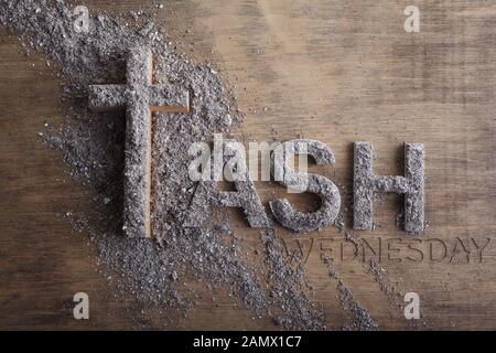 Ash wednesday word written in ash and christian cross symbol as a religion concept Stock Photo