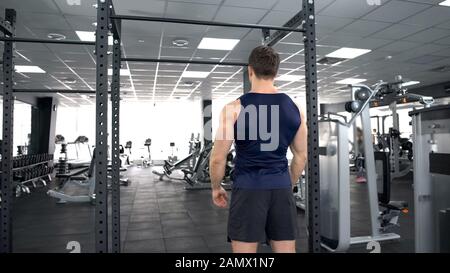 Sportive man warming up before gym workout, fitness lifestyle, bodybuilding Stock Photo
