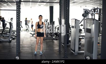 Active sport woman standing with jumping rope, gym workout, healthy lifestyle Stock Photo