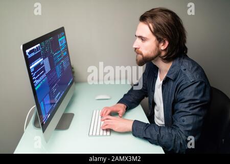 Programmer coding in the computer. Stock Photo