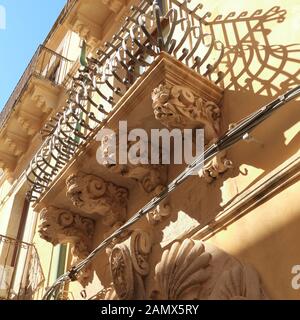 Baroque corbels with mascarons. Sculptured balcony brackets. Baroque architecture in Sicily Stock Photo