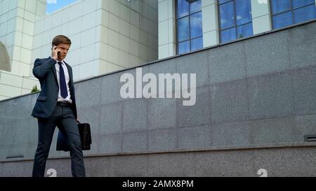 Handsome businessman receiving phone call with bad news failed contract, problem Stock Photo