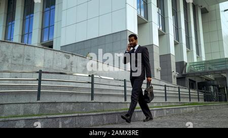 African American businessman talking on phone, stressed and overworked, deadline Stock Photo