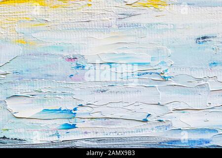 Strokes of artistic oil paint on the canvas. Hand drawn painting. White, blue, yellow colored fragment of a modern artwork. Brushstrokes of paint. Stock Photo
