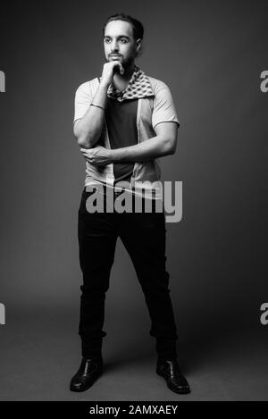 Young bearded Indian man against gray background Stock Photo