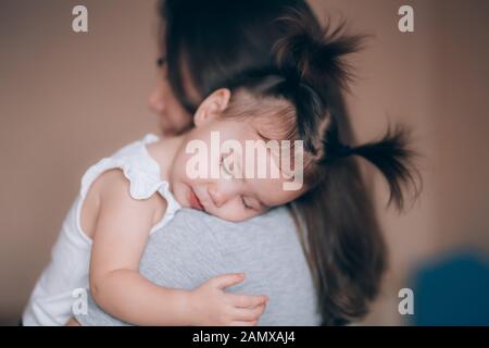 Young mother holding her little child girl. Stock Photo