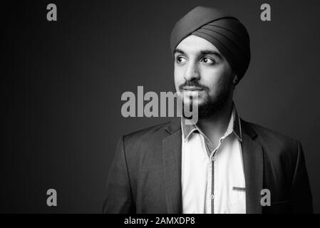 Young bearded Indian Sikh businessman wearing turban Stock Photo