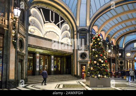 Glimpse of San Federico Gallery with a Christmas tree in front of the entrance of the historic Lux Cinema in the city centre of Turin, Piedmont, Italy