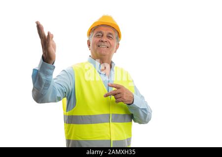 Friendly old male builder presenting blank copyspace with hands isolated on white studio background Stock Photo